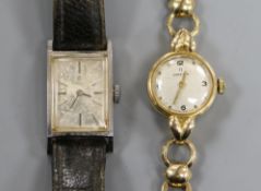 A lady's 9ct gold Omega manual wind wrist watch on 9ct gold bracelet and a lady's stainless steel