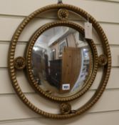 A circular gilt convex wall mirror W.46cm