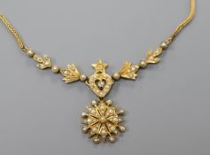 An Edwardian yellow metal, diamond and seed pearl pendant necklace, 48cm.