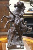 A bronze group of a man and a stallion height 64cm