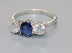 A white metal, sapphire and diamond three stone ring, size L.