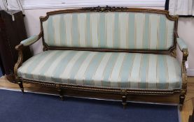 A Louis XVI style carved giltwood canape raised on turned fluted legs W.188cm