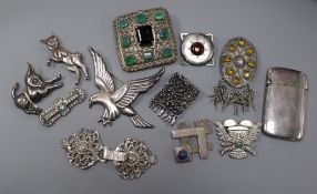 Twelve assorted silver and white metal brooches etc. and a silver card case.