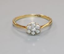 A mid 20th century 18ct gold and diamond cluster ring, size L.