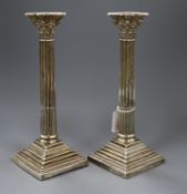 A pair of late Victorian silver corinthian column candlesticks by Walker & Hall, Sheffield, 1894,