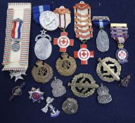 A group of military and Red Cross badges