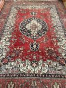 A Persian design red ground carpet 250 x 350cm