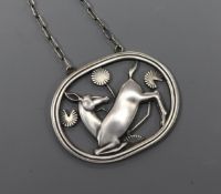 A Danish Georg Jensen sterling silver oval kneeling dear pendant, no. 95, on chain, pendant 43mm.