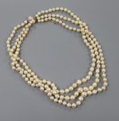A triple strand baroque cultured pearl necklace, with a yellow metal and twin cultured pearl set
