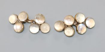 A pair of early 20th century 9ct gold and triple moonstone set cufflinks.