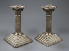 A pair of late Victorian silver corinthian column dwarf candlesticks by Joseph Cook & Son,