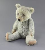 A 1930's blue Chiltern teddy bear, faded, 20in.