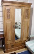 A late Victorian beech mirrored wardrobe W.113cm