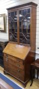 A large George III mahogany bureau, with later bookcase top W.96cm