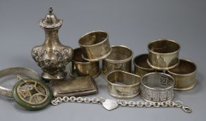 Seven assorted silver napkin rings, silver pepper, silver snuff box, bracelet and three other