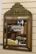 A French embossed brass wall mirror W.48cm