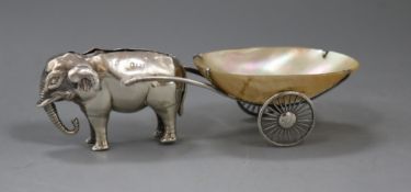 An early 20th century novelty pin cushion modelled as an elephant pulling a mother of pearl cart,
