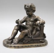 A bronze figure of Cupid reading height 18.5cm