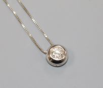 A modern 9ct gold and solitaire diamond set pendant necklace, stone diameter approximately 4.1mm,