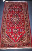 A red and blue ground rug 132 x 70cm