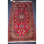 A red and blue ground rug 132 x 70cm