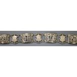 An Egyptian? white metal belt, pierced and decorated with scarabs and figures, 93cm.