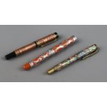 Three ornate fountain pens, cased