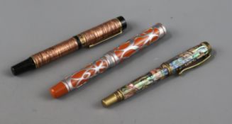 Three ornate fountain pens, cased