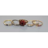 An 18ct gold ring (lacking one stone) and four yellow metal gem set rings including two 9ct.