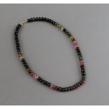A modern single strand multi coloured facet cut tourmaline necklace, with 18ct clasp, 42cm.