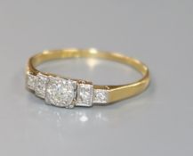 A 1920's/1930's 18ct gold, platinum and stepped graduated five stone diamond ring, size Q.