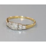 A 1920's/1930's 18ct gold, platinum and stepped graduated five stone diamond ring, size Q.