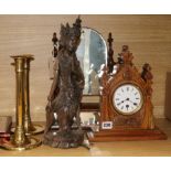 A late Victorian carved oak timepiece, a pair of brass candlesticks, a toilet mirror and a carved