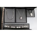 A group of assorted modern Tusk steel jewellery including bracelets and pendants.
