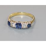 An 18ct gold and platinum, sapphire and diamond five stone ring, size M/N.