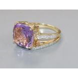 A modern 14ct gold, amethyst and diamond dress ring, size O.