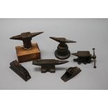 Three miniature anvils, two carpentry planes and a miniature vice tallest 11cm