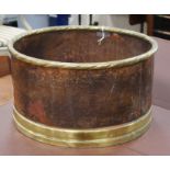 A circular copper and brass log bin W.52cm