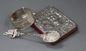 A late Victorian ornate silver bangle (a.f.), a silver mounted day book and a Dutch white metal