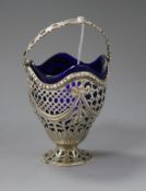 A late Victorian pierced silver sugar basket with blue glass liner, John Henry Rawlings, London,
