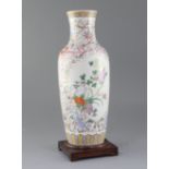 A Chinese famille rose baluster vase, painted with chrysanthemums amid rockwork, on a ground painted
