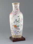 A Chinese famille rose baluster vase, painted with chrysanthemums amid rockwork, on a ground painted