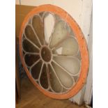 A circular glazed window panel W.115cm