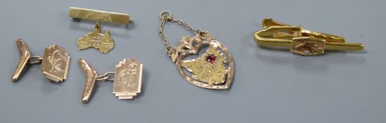 A pair of 9ct gold cufflinks with 'boomerang' terminal, a 9ct gold map of Tasmania pendant, a 9ct '