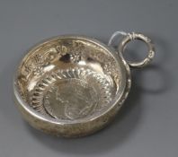 An early 19th century French white metal taste vin with ring handle and inset coin base, 11.2cm inc.