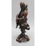 A late 19th/early 20th century Chinese hardwood figure of a luohan Height 43.5cm