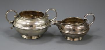 A George V silver two handled sugar bowl and matching cream jug, Birmingham, 1919.