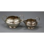 A George V silver two handled sugar bowl and matching cream jug, Birmingham, 1919.