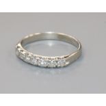 A white metal and seven stone diamond half eternity ring, size P.