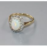 A 9ct gold, white opal and diamond oval cluster ring, size K.